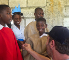 Gerard Butler directing Haitian schoolchildren in a Nativity play - Love Reaches Everywhere